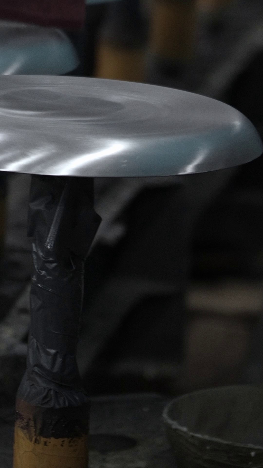 A newly formed aluminum cookware vessel at the press